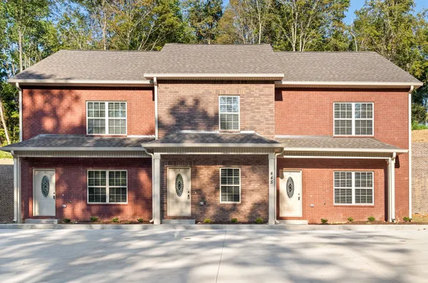front view of a brick house with a windows