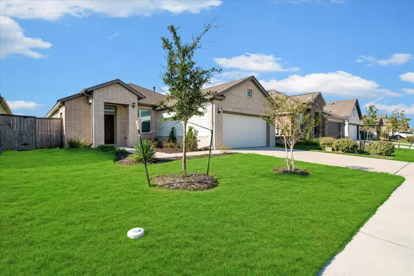 a front view of house with yard and green space