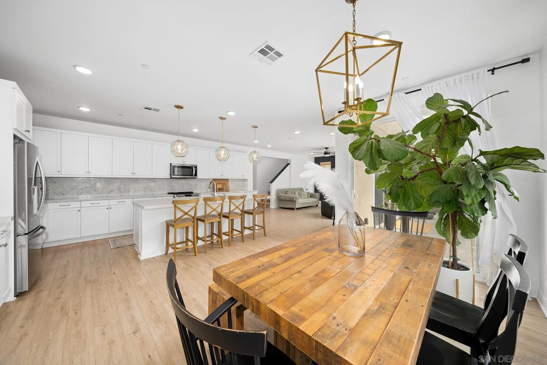 8850 Weston Road Santee, CA 92071 - Photo 11 of 44 a dining room with furniture and a chandelier