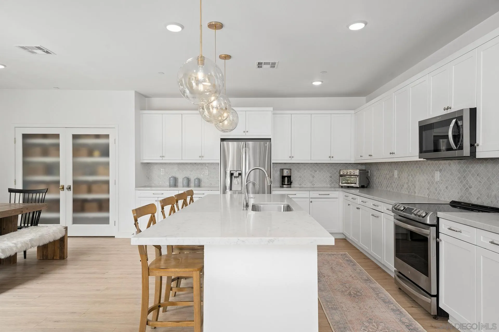 8850 Weston Road Santee, CA 92071 - Photo 5 of 44 a kitchen with stainless steel appliances granite countertop a sink a stove and a refrigerator