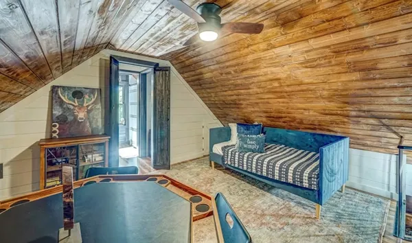 a view of balcony with two chairs and a potted plant