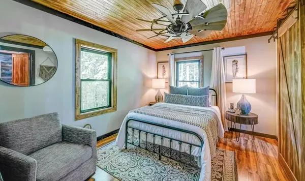 a bedroom with a bed couch and window