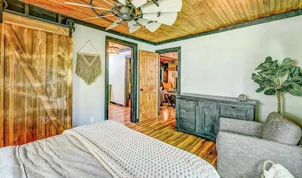 a bedroom with a bed and a potted plant