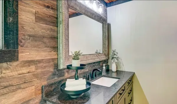 a bathroom with a sink a mirror and a toilet