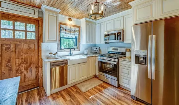 a kitchen with stainless steel appliances a refrigerator sink and cabinets