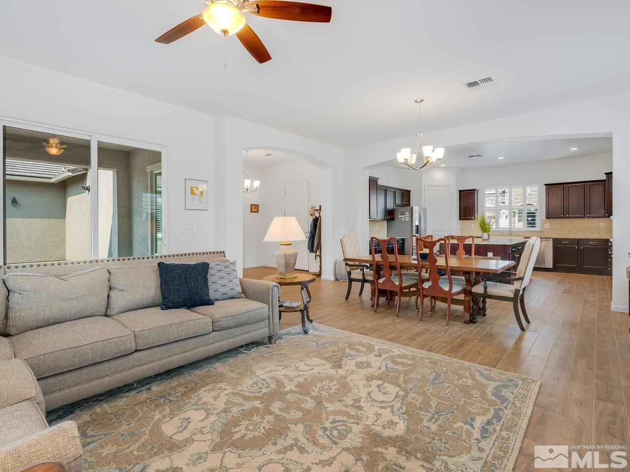 9583 Gazala Lane Reno, NV 89521 - Photo 15 of 36 a living room with furniture kitchen view and a dining table