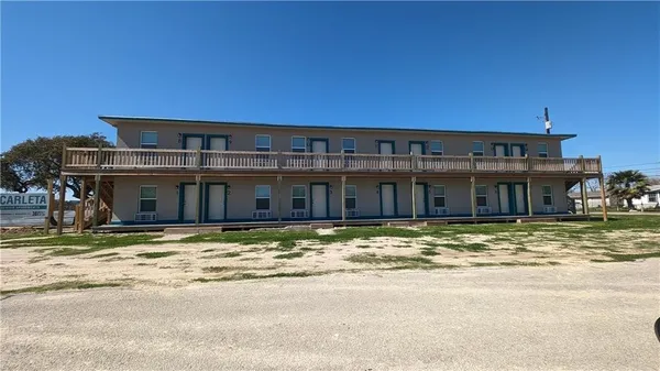 a view of a big house next to a big yard