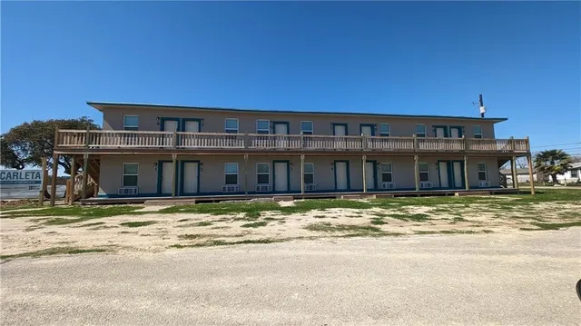 a view of a big house next to a big yard