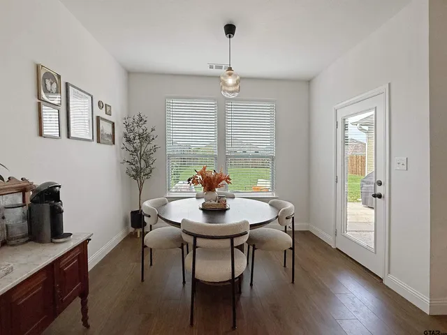 a view of a dining room with furniture window and wooden floor