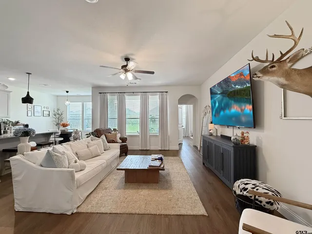a living room with furniture and a flat screen tv