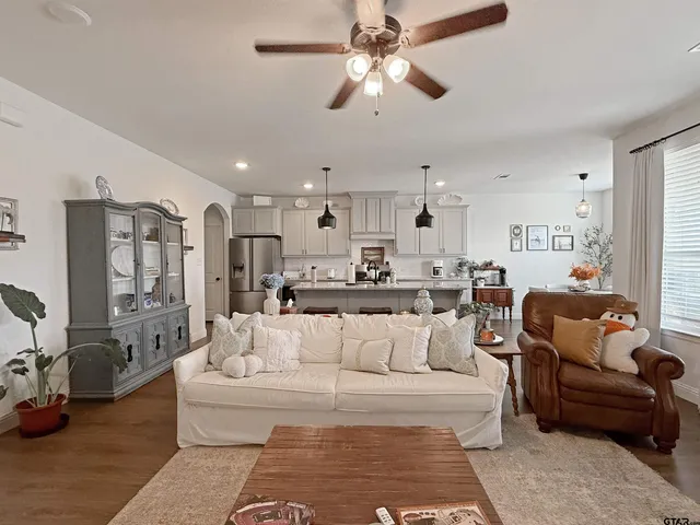 a living room with furniture and kitchen view