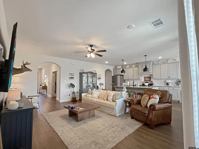 a living room with furniture and a chandelier