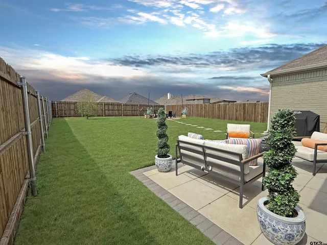 a view of a garden with an outdoor seating