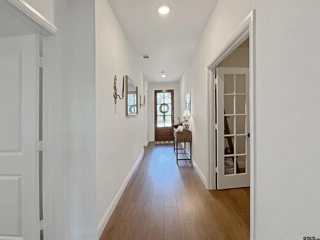 a view of hallway with wooden floor