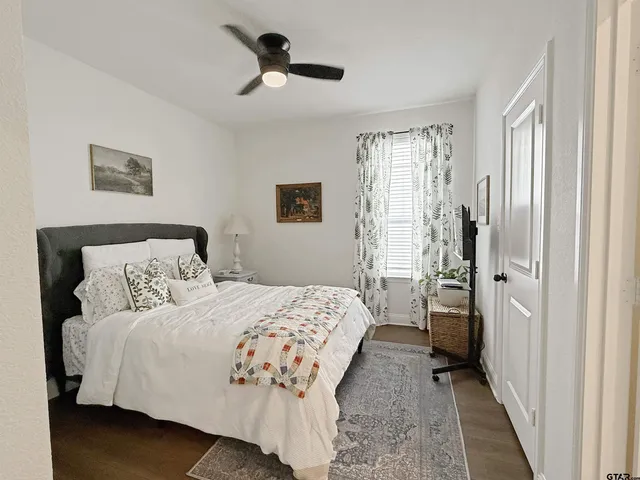 a bedroom with a large bed and a chandelier