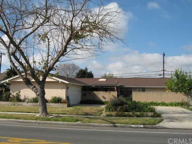 12571 Foster Road Rossmoor, CA 90720 - Photo 1 of 1 Exterior Front. Courtyard and Koi pond behind block wall.