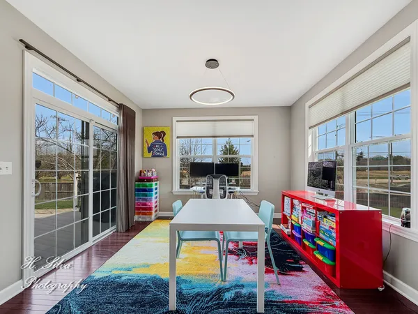 a living room with furniture a flat screen tv and a floor to ceiling window