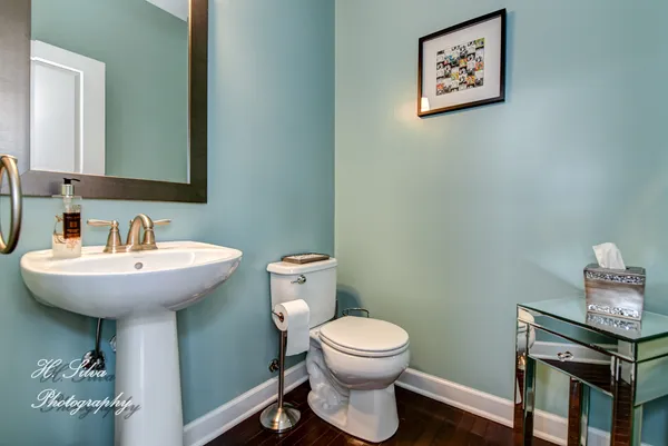 a bathroom with a toilet a sink and mirror