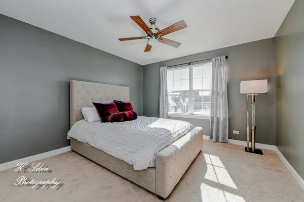 a bedroom with a large bed and a large window