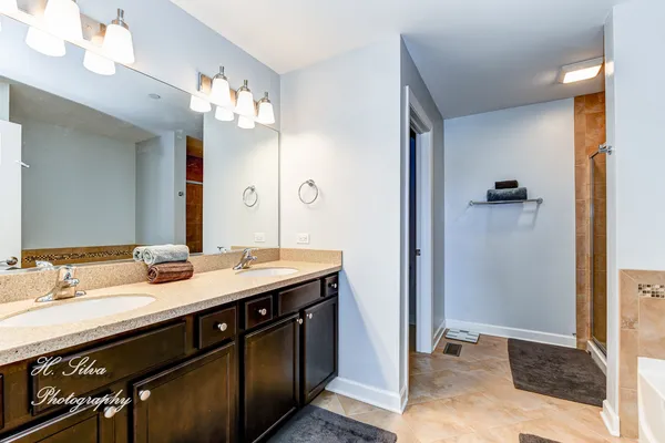 a bathroom with a granite countertop sink a large mirror and a shower