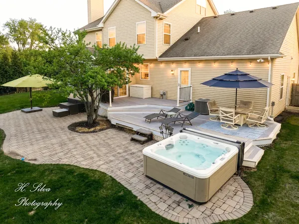 a view of a house with backyard and sitting area