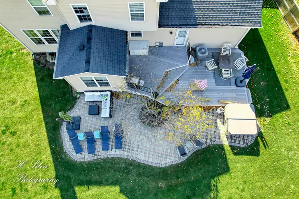 an aerial view of residential house with outdoor space and trees all around