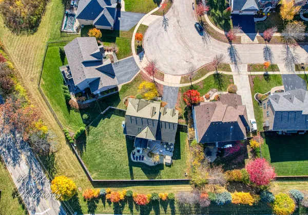 an aerial view of residential house with outdoor space and swimming pool