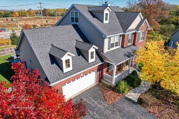 an aerial view of a house with a yard