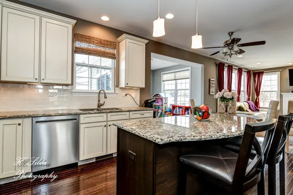 a kitchen with granite countertop a sink appliances and cabinets