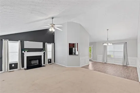 a big room with chandelier and fireplace