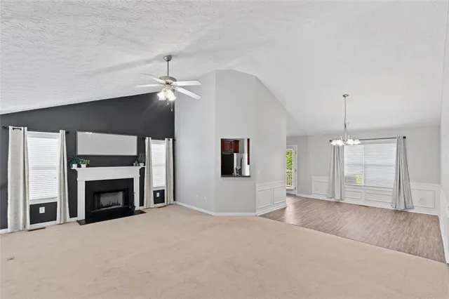 a big room with chandelier and fireplace