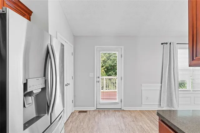 an empty room with wooden floor and a window