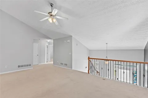 a view of a livingroom with a ceiling fan and window