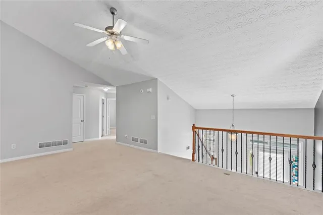a view of a livingroom with a ceiling fan and window