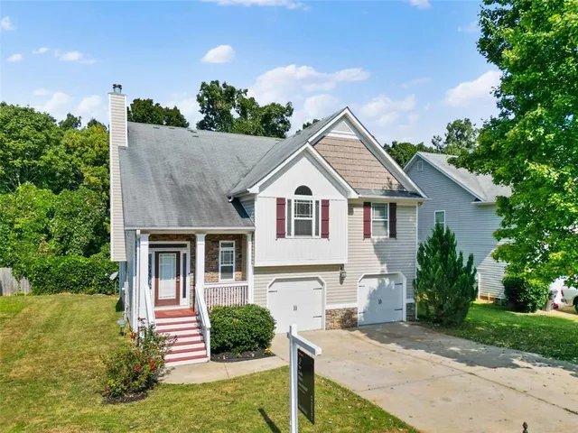 a front view of a house with garden