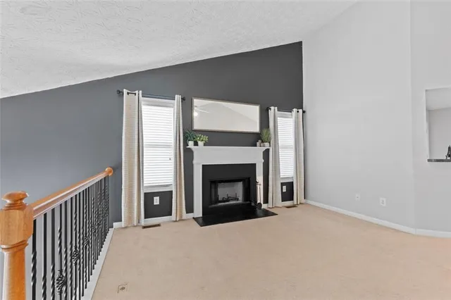 a big room with fireplace and a window