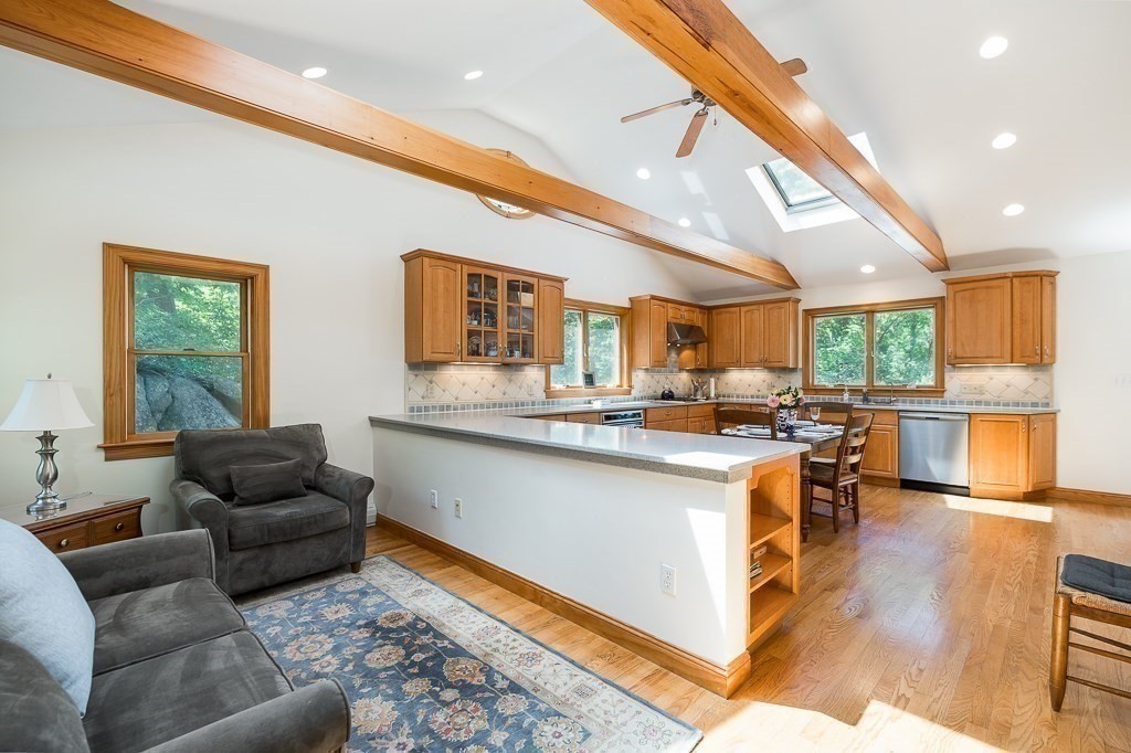 20 R Edgemoor Road Gloucester, MA 01930 - Photo 18 of 33 a kitchen with stainless steel appliances granite countertop a couch and a living room view