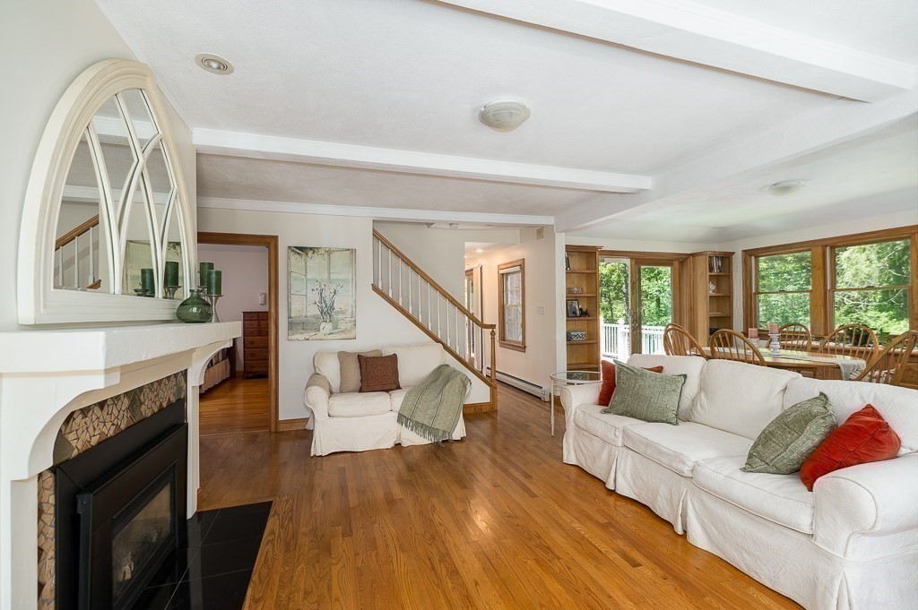20 R Edgemoor Road Gloucester, MA 01930 - Photo 23 of 33 a living room with fireplace furniture and a wooden floor