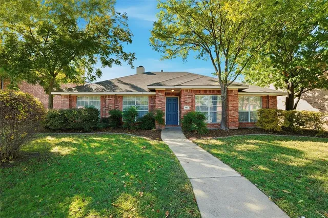 a front view of a house with yard patio and green space