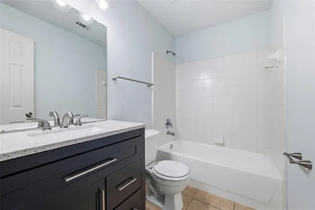 a bathroom with a granite countertop sink toilet mirror and shower