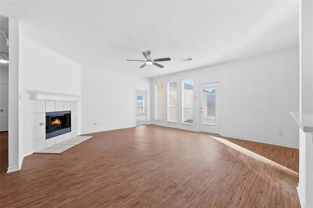 wooden floor in an empty room with a fireplace