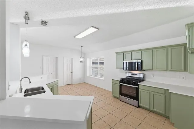 a kitchen with a sink and a stove top oven