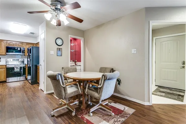 a view of a dining room with furniture and wooden floor