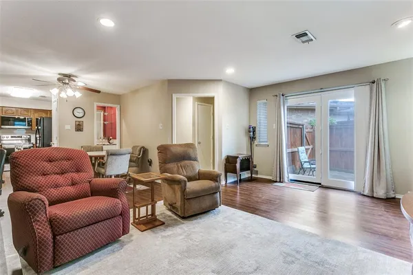 a living room with furniture and wooden floor