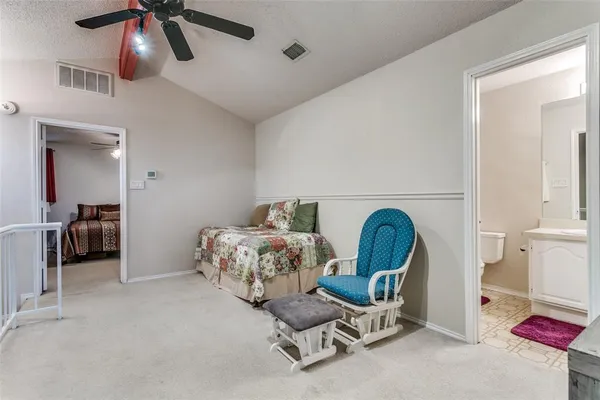 a bedroom with a bed a desk and chair