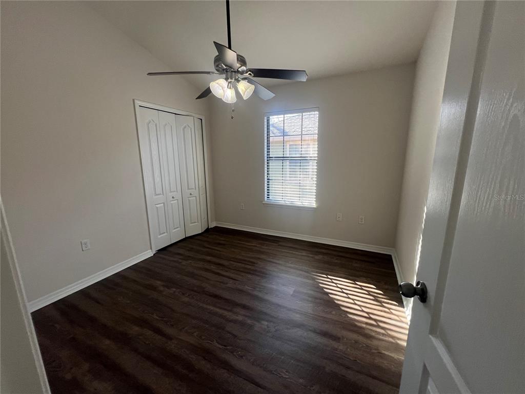 5706 Kingletsound Lithia, FL 33547 - Photo 11 of 16 a view of an empty room with wooden floor and a window
