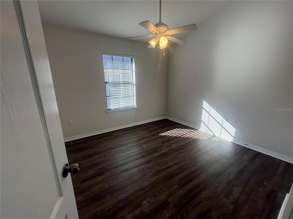 5706 Kingletsound Lithia, FL 33547 - Photo 12 of 16 an empty room with wooden floor and windows