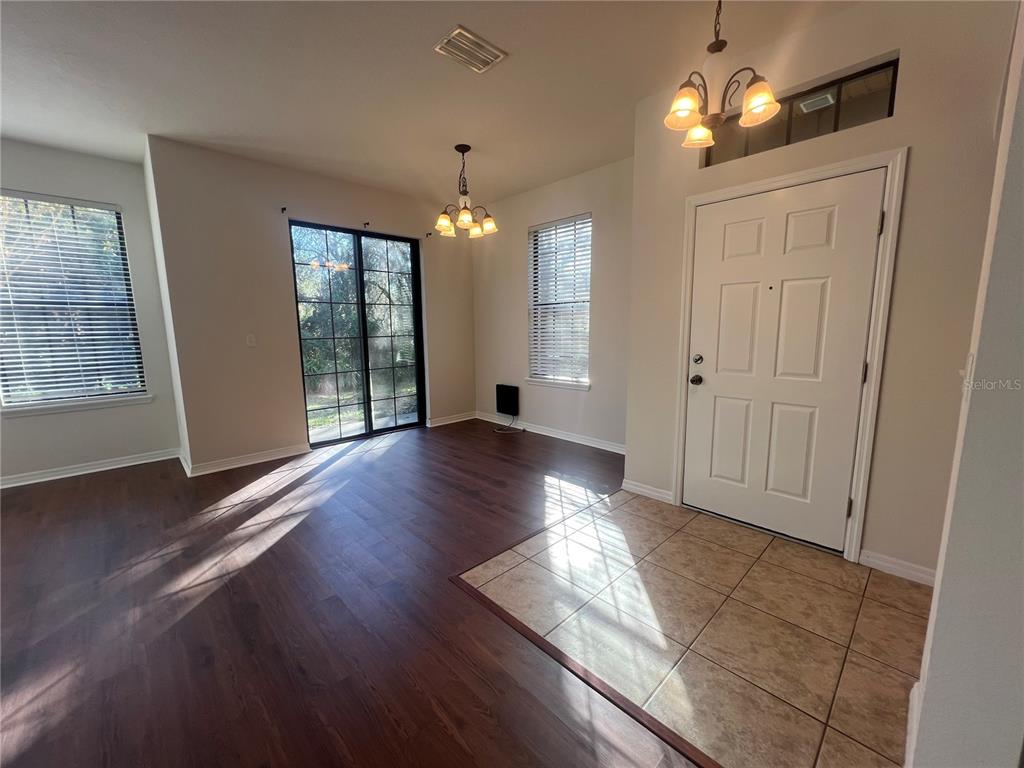 5706 Kingletsound Lithia, FL 33547 - Photo 2 of 16 an empty room with wooden floor and windows