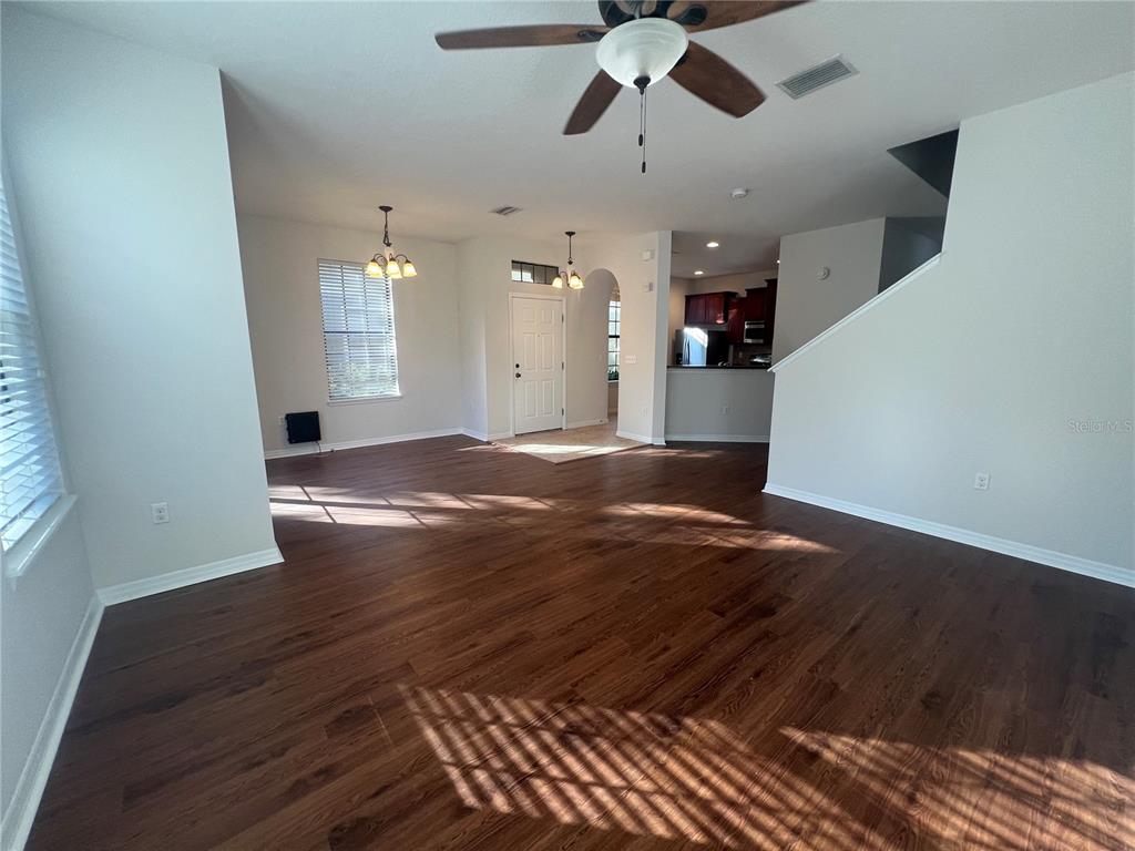 5706 Kingletsound Lithia, FL 33547 - Photo 3 of 16 a view of an empty room with wooden floor and a window