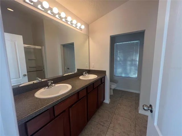 a bathroom with a sink double vanity and a mirror